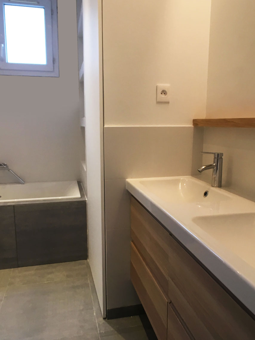 Salle de bain avec meuble vasque en chêne et baignoire — rénovation Paris
